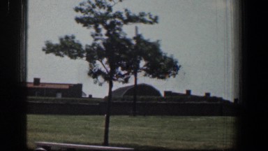 1961: a large grassy ground with certain buildings on one side BALTIMORE