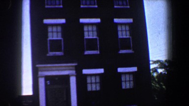 1964: exterior of a 3 storey brick townhouse against blue sky SAINT LOUIS