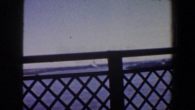 1964: view of an industrial harbor from a bridge out the side of a car