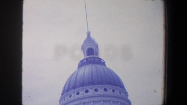 1964: a tall building with a dome roof and pointed spotted with lined windows