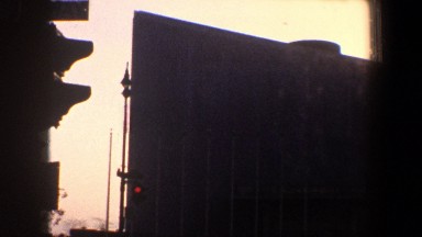 1960: camera pans across large building with dome and attached high-rise
