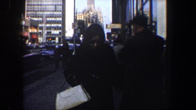 1960: man waiting on the street for his ride. NEW YORK CITY