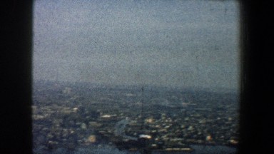 1960: people standing at the top of the building overlooking the tops