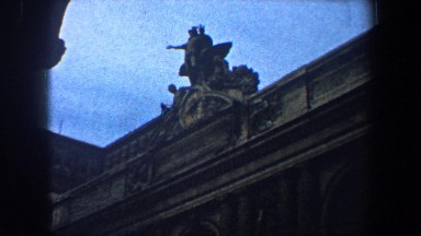 1960: large building with some structure over the roof at the entrance. NEW YORK