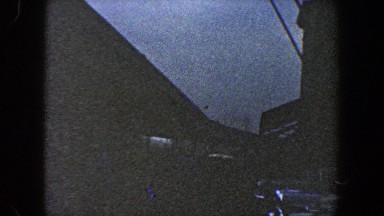 1960: a bridge, a long bridge in half darkness. a camera moving