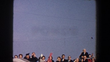 1960: Nicely Dressed People Stand Behind a Rail Waving in New York City