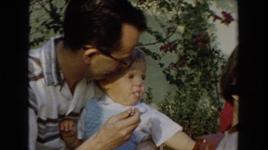 1962: father feeding his son some food. GLENDALE, CALIFORNIA