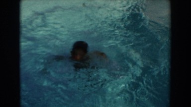 1962: kid having a great time in a body of water outside