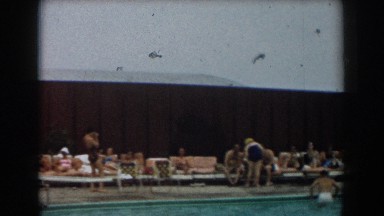 1961: a group of people laying on the lounge chairs gathered outside