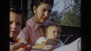 1962: mother feeds toddler with spoon GLENDALE, CALIFORNIA