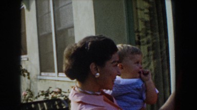 1962: toddler tries to pull earring off mother's ear GLENDALE, CALIFORNIA