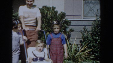 1962: a baby wanders from his stroller, flanked by his mom and siblings