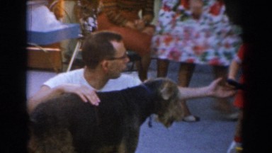 1962: children play with toys gathered around family with pet GLENDALE
