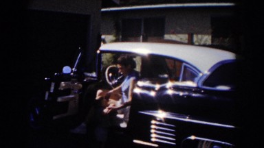 1962: mother and son getting out of a car. GLENDALE, CALIFORNIA