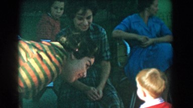 1962: children playing in front of a small gathering of men and women GLENDALE
