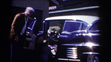 1962: man let's child get behind wheel of car GLENDALE, CALIFORNIA
