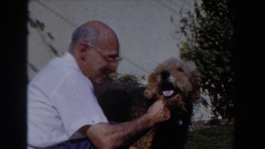1962: older couple playing ball with the dog GLENDALE, CALIFORNIA