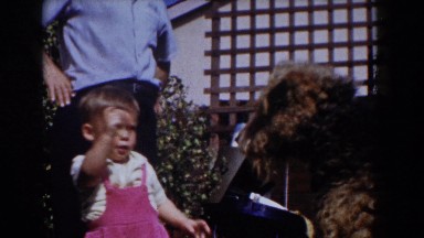 1962: toddler feeding a doggy outside. GLENDALE, CALIFORNIA