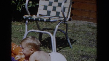 1962: a baby wearing a diaper climbing into a pool and smiling GLENDALE