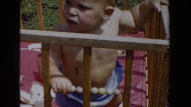 1962: baby with a hat sits in his crib GLENDALE, CALIFORNIA