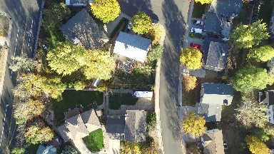 aerial view of a house as a balloon descends into the yard. COLORADO