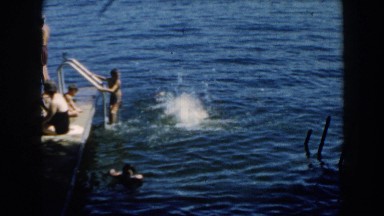 1960: Group of People Hanging Out at the End of a Dock Jumping Off