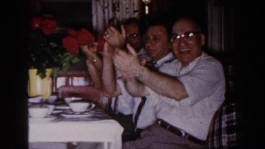 1960: group of people at a restaurant enjoying each other's company