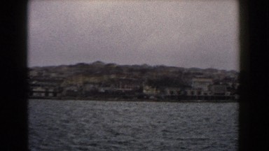 1960: panoramic of the seaside with city in the background.