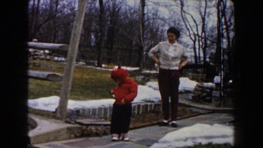 1961: mother and son standing on the sidewalk DEARBORN, MICHIGAN