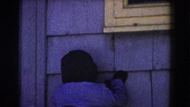 1961: child playing by the edge of the house. DEARBORN, MICHIGAN