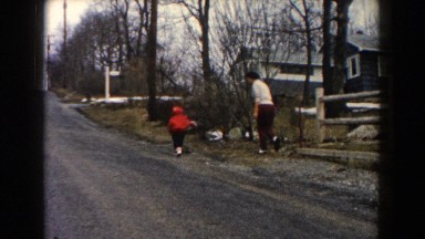 1961: people running down a road laughing and smiling and chasing