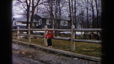 1961: a boy crossing under the wooden handrail near to plantation DEARBORN