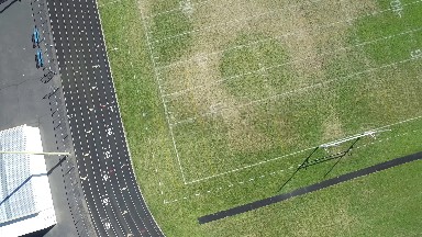 aerial view of an athletic field with grass and markings that is empty COLORADO