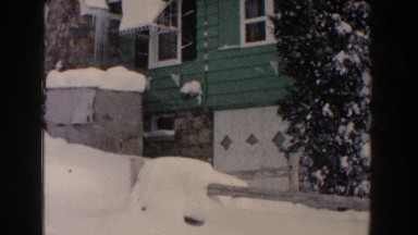 1961: a house and the roadways which are fully covered snow