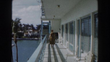 1960: Woman Standing on Balcony in Miami, Florida