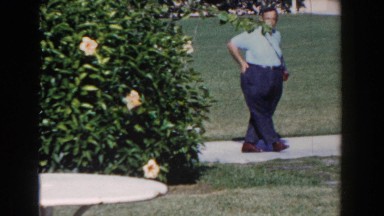 1961: people standing in a yard on the sidewalk NASSAU