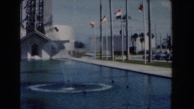1961: fountain in reflecting pool is in front of tower with observation deck