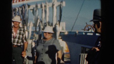 1961: Man and Woman Holding Up Fish Caught in Nassau, Bahamas
