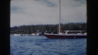 1961: A Boat Sitting in the Water at the Shoreline in Nassau