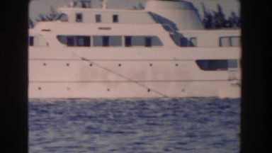 1961: large white vessel lying in the blue water of the lake NASSAU