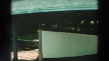 1964: a wooden pier that is holding a small boat underneath LAKE WINNEBAGO