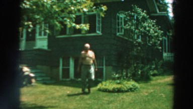 1964: man walking around outside house enjoying the view LAKE WINNEBAGO