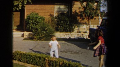 1958: little kids playing outside on the sidewalk. CALIFORNIA