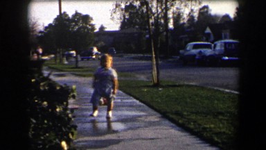 1958: toddler walking in puddles CALIFORNIA