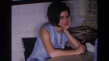 1966: A Good-Looking Young Lady Smiling During a Chat at the Table