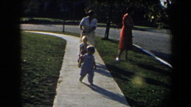 1958: two mothers walking their children down a sidewalk. CALIFORNIA