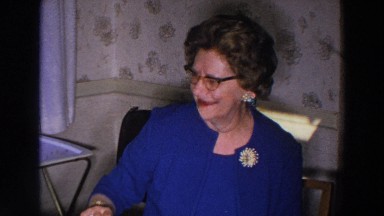 1966: grandmother sitting view people indoor happy wearing blue dress MADISON
