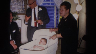1966: grand parents are attending a cute baby in the cradle MADISON WISCONSIN