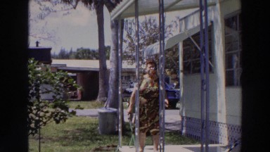 1966: a woman taking a walk with her pet on a beautiful and sunny day