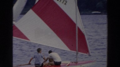 1966: a father and his son on a yacht, enjoying the views of the ocean WISCONSIN